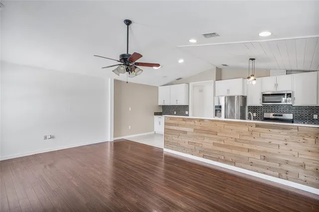 a view of a kitchen with a sink stainless steel appliances and cabinets