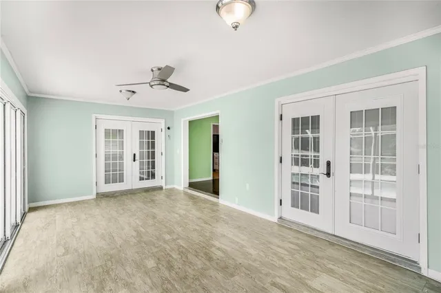a view of a room with wooden floor and windows