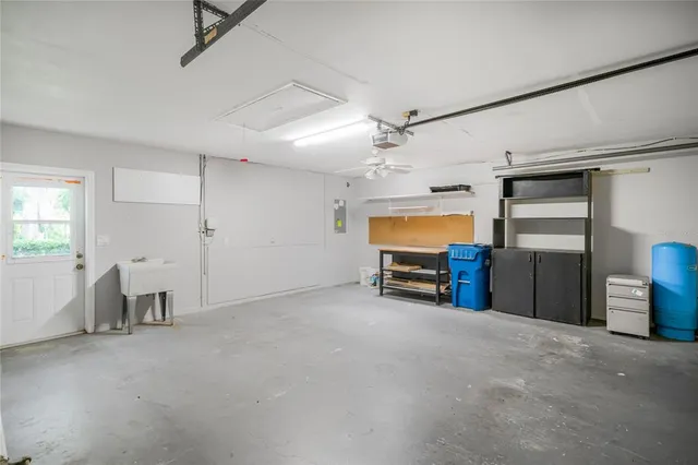 a view of a patio with table and chairs potted plants and large tree