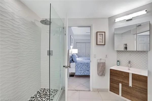 a bathroom with a shower and a sink