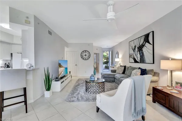 a living room with patio furniture and a fireplace