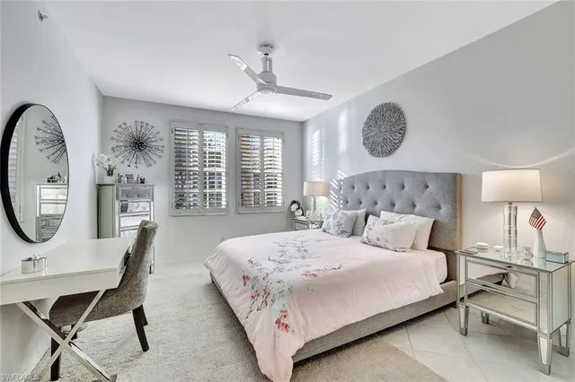 a bedroom with a bed a window and a chandelier