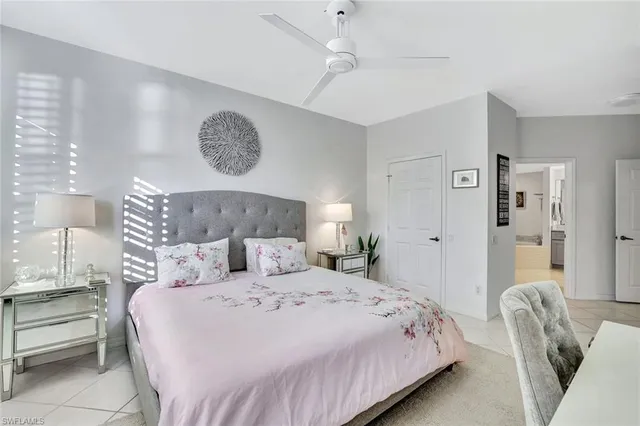a bedroom with a large bed and a chandelier