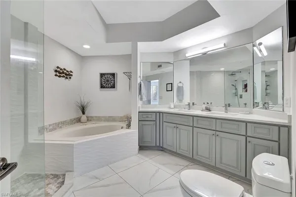 a spacious bathroom with a granite countertop sink mirror and toilet