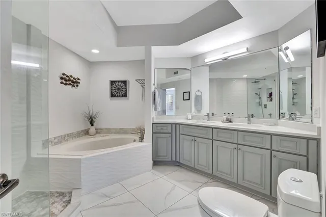 a spacious bathroom with a granite countertop sink mirror and toilet