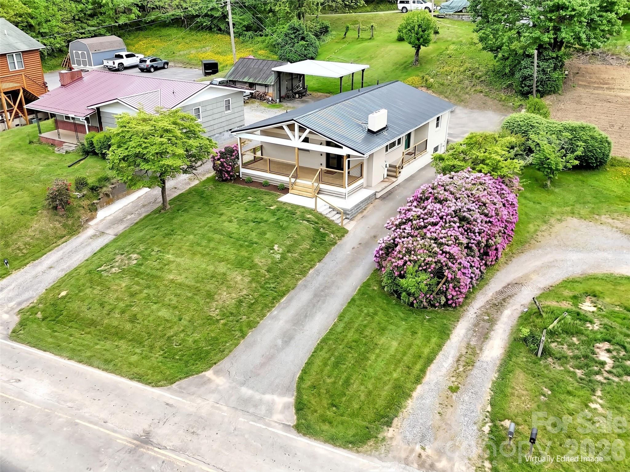 3575 Dellwood Road Waynesville, NC 28786 - Photo 33 of 43 an aerial view of a house with a garden and swimming pool