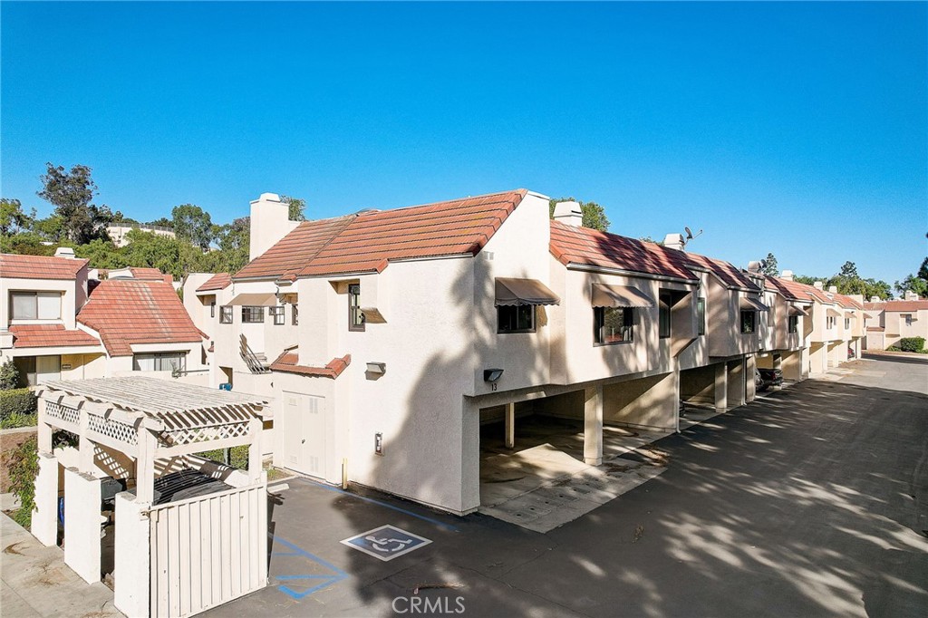 23 Pearl Laguna Niguel, CA 92677 - Photo 24 of 37 a view of a patio with table and chairs under an umbrella with a barbeque