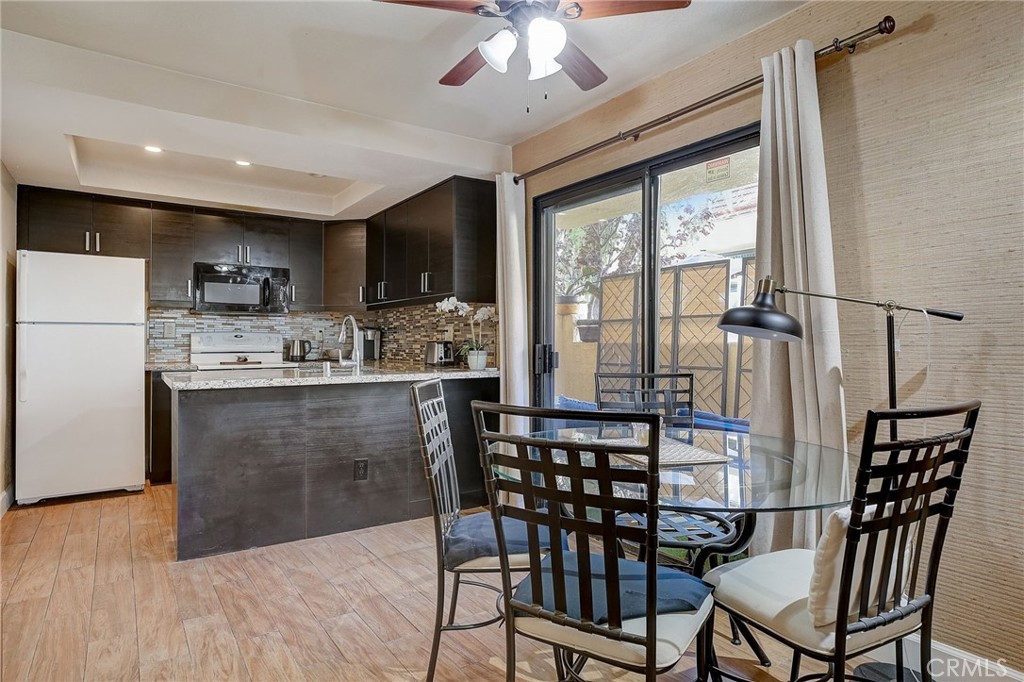 23 Pearl Laguna Niguel, CA 92677 - Photo 7 of 37 a kitchen with a table chairs refrigerator and microwave