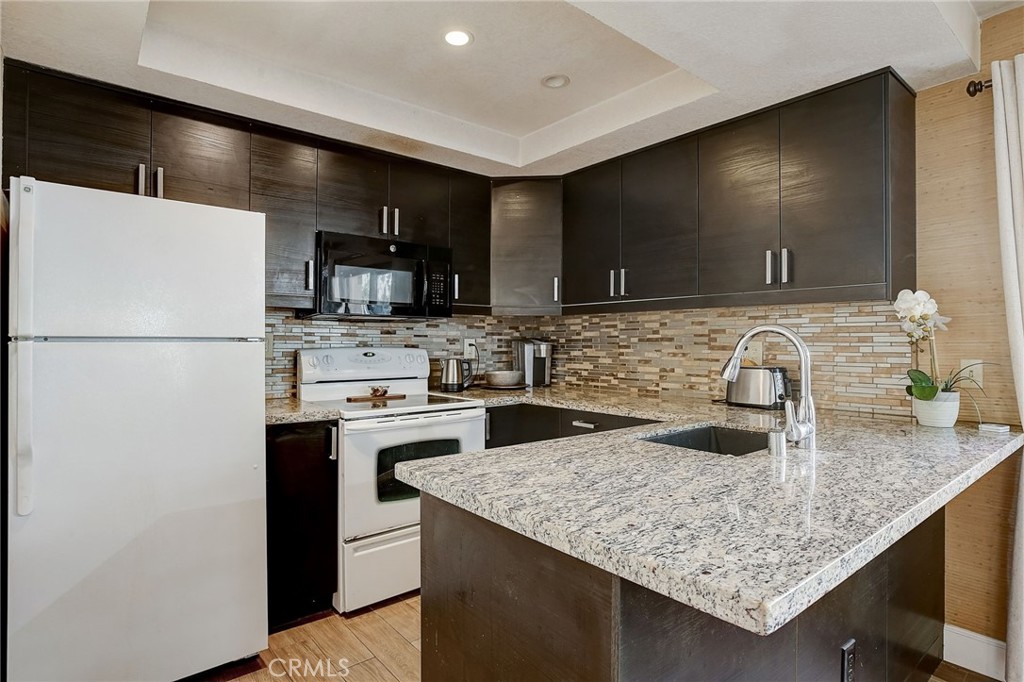 23 Pearl Laguna Niguel, CA 92677 - Photo 10 of 37 a kitchen with stainless steel appliances granite countertop a sink stove and refrigerator