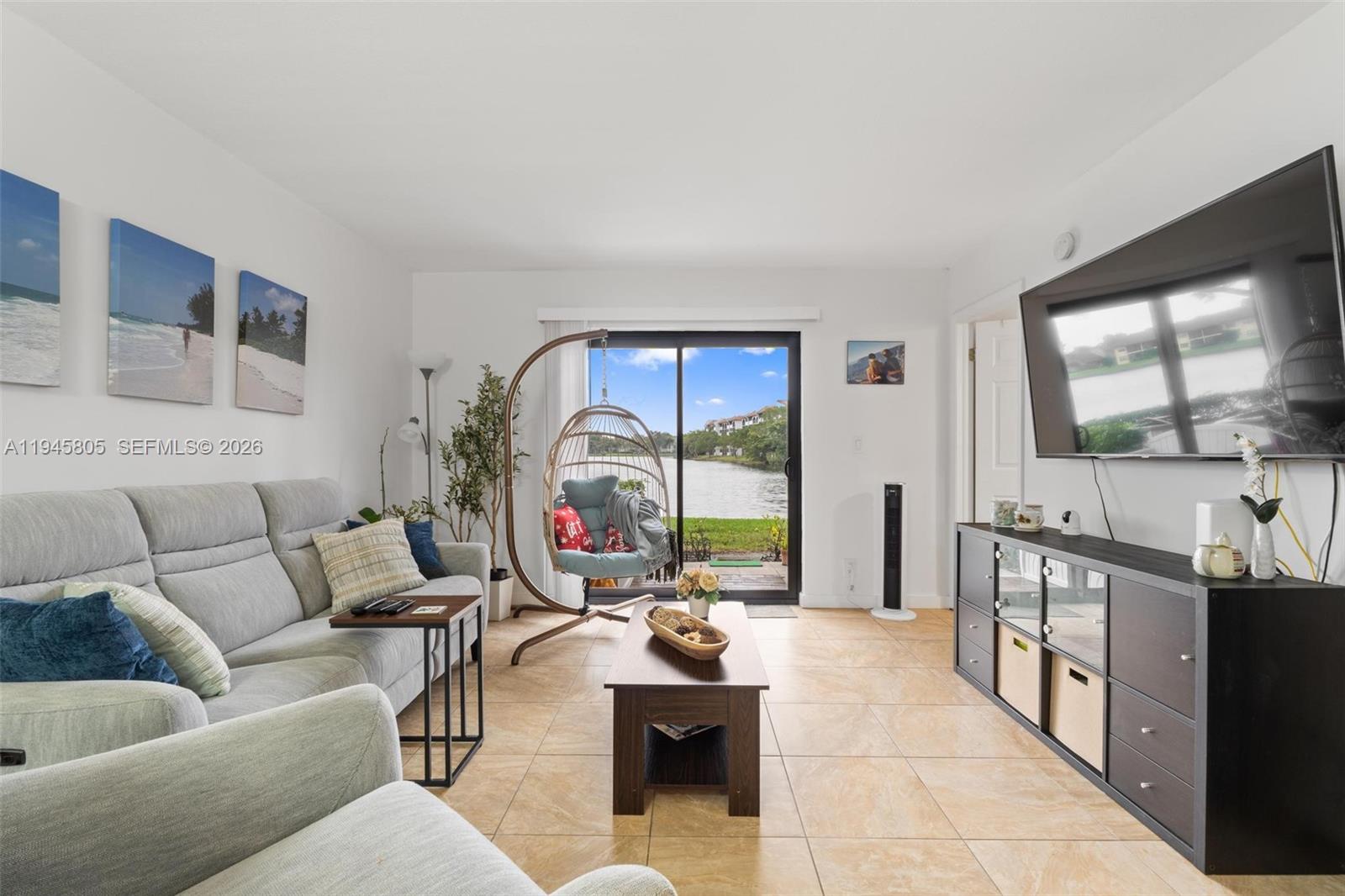 10005 Winding Lake Road, Unit 106 Sunrise, FL 33351 - Photo 11 of 41 a living room with furniture and a large window