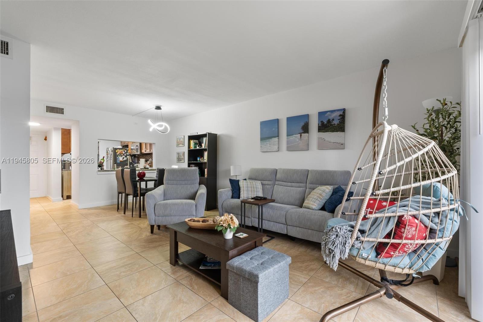 10005 Winding Lake Road, Unit 106 Sunrise, FL 33351 - Photo 12 of 41 a living room with furniture and a flat screen tv