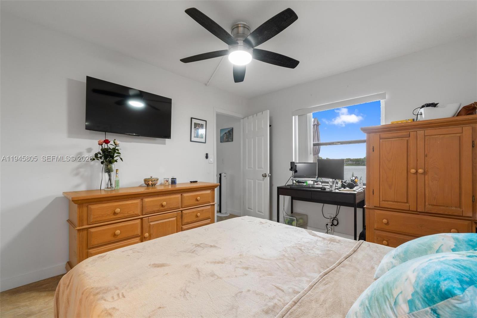 10005 Winding Lake Road, Unit 106 Sunrise, FL 33351 - Photo 15 of 41 a bedroom with a bed and a flat screen tv