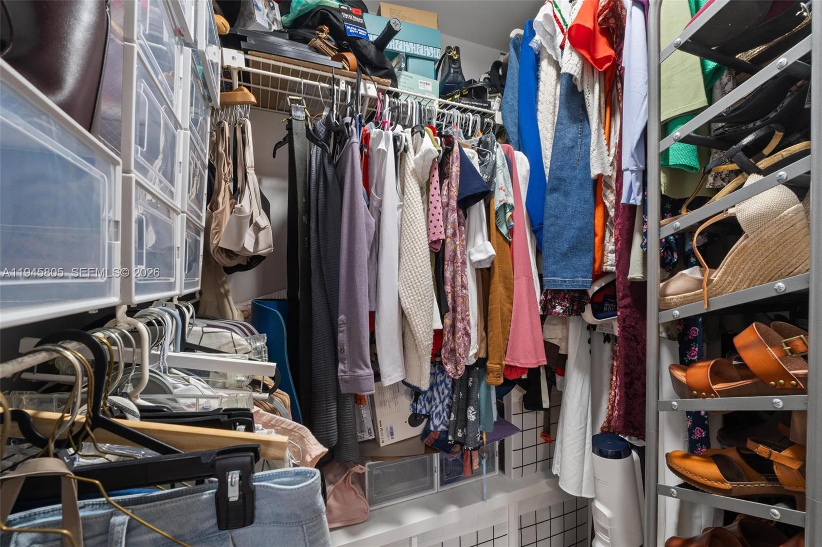 10005 Winding Lake Road, Unit 106 Sunrise, FL 33351 - Photo 16 of 41 a view of walk in closet with clothes