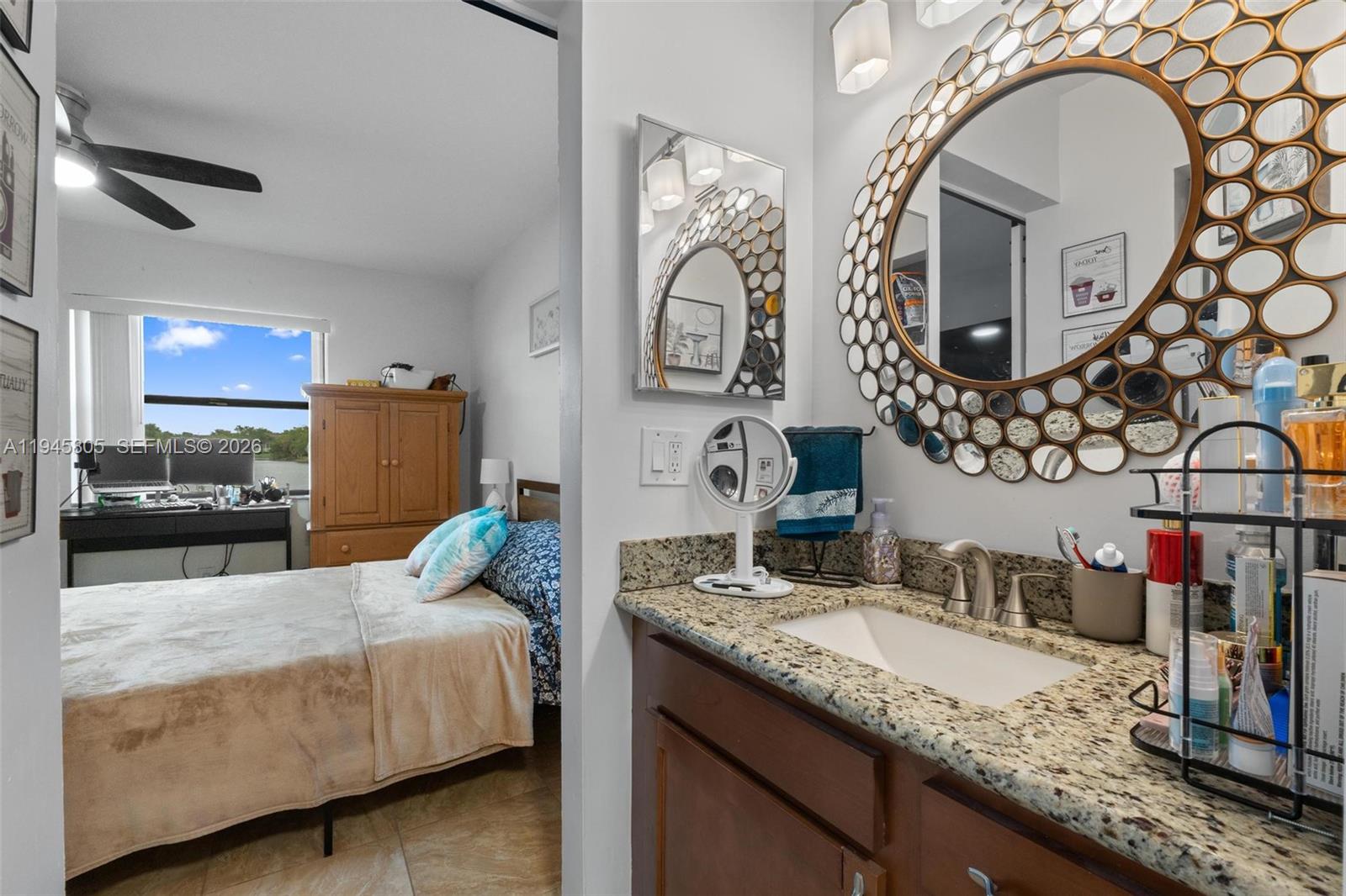 10005 Winding Lake Road, Unit 106 Sunrise, FL 33351 - Photo 19 of 41 a en suite bathroom with a granite countertop sink and a mirror
