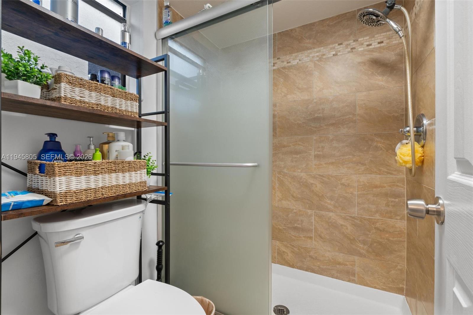 10005 Winding Lake Road, Unit 106 Sunrise, FL 33351 - Photo 20 of 41 a bathroom with a granite countertop sink a toilet a shower and a mirror