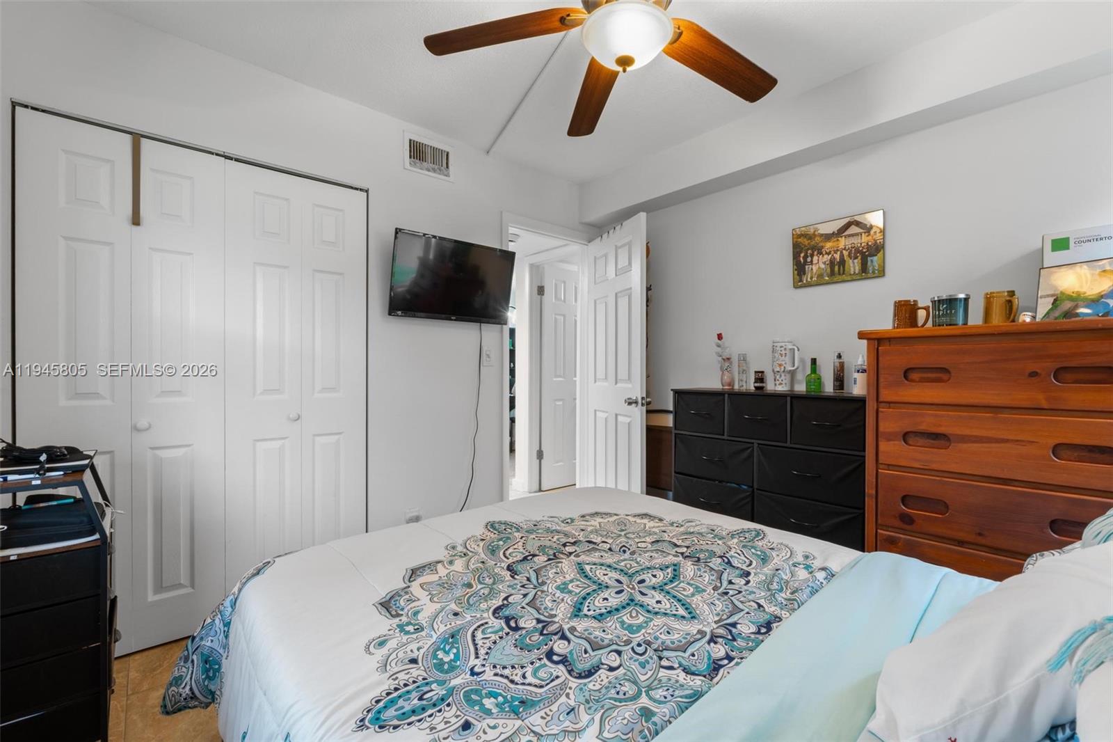 10005 Winding Lake Road, Unit 106 Sunrise, FL 33351 - Photo 22 of 41 a bedroom with a bed and a television