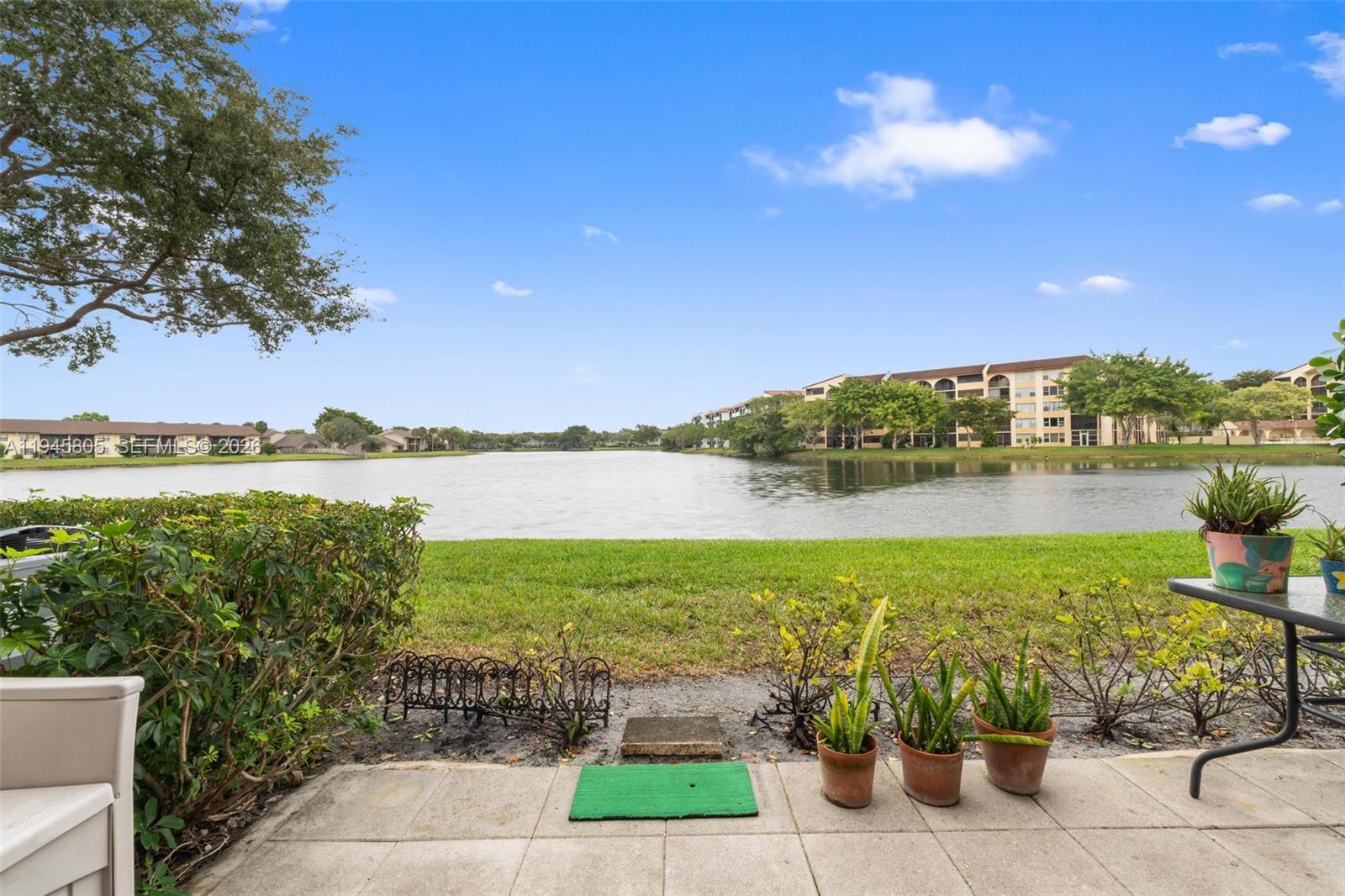 10005 Winding Lake Road, Unit 106 Sunrise, FL 33351 - Photo 24 of 41 a view of a lake with a big yard
