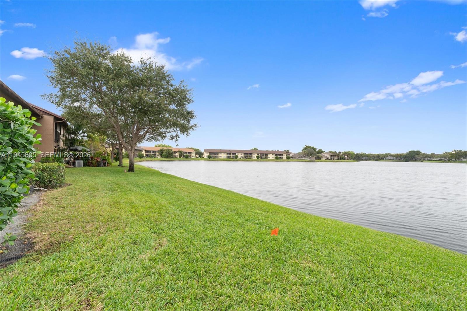 10005 Winding Lake Road, Unit 106 Sunrise, FL 33351 - Photo 26 of 41 a view of a lake with a big yard