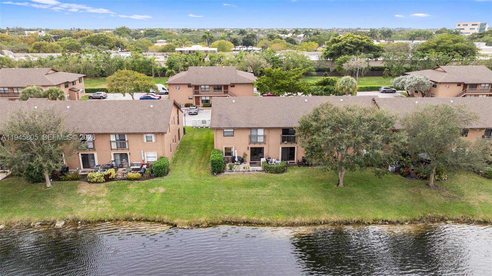 10005 Winding Lake Road, Unit 106 Sunrise, FL 33351 - Photo 34 of 41 an aerial view of a house with a yard and lake view