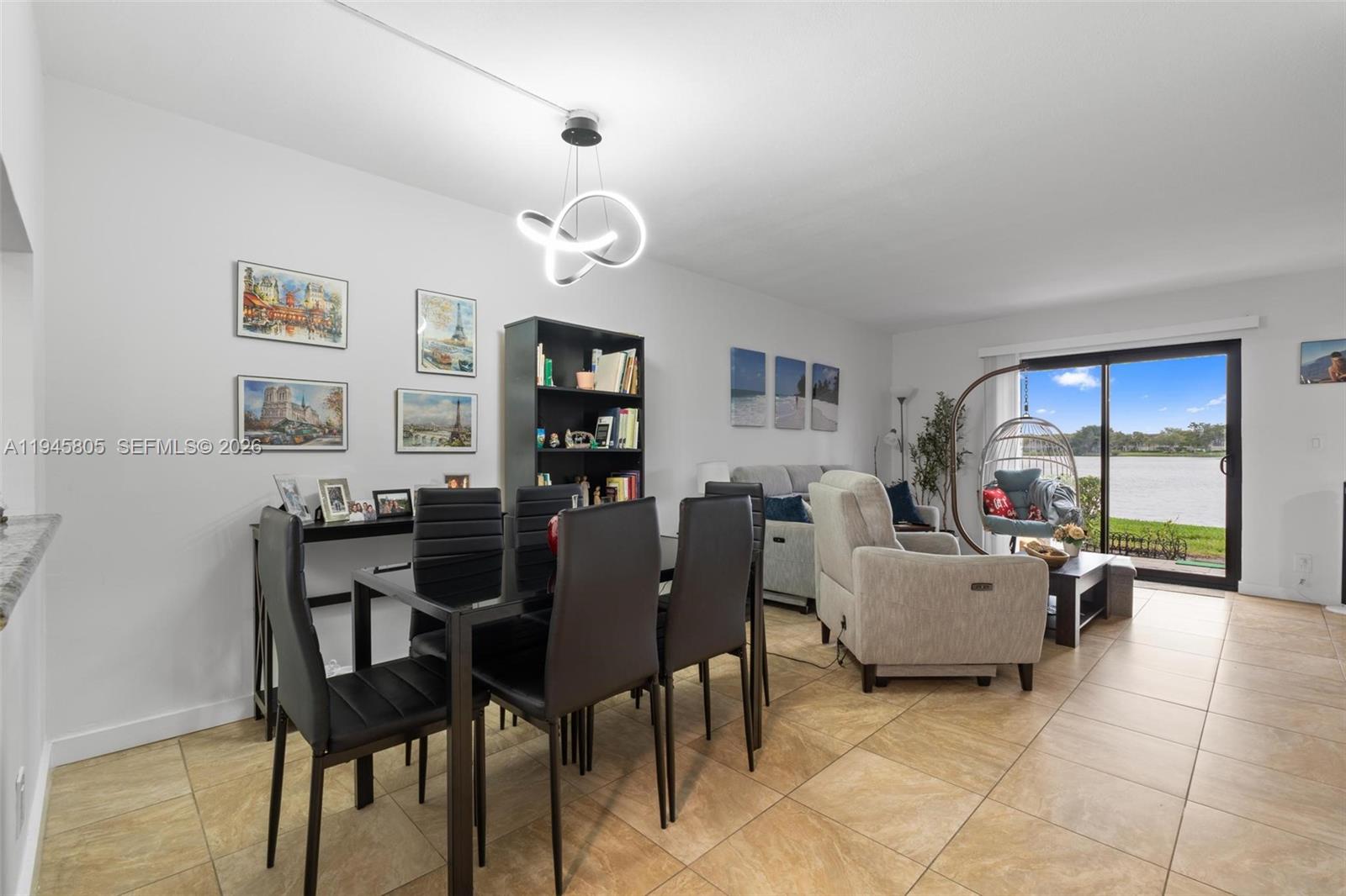 10005 Winding Lake Road, Unit 106 Sunrise, FL 33351 - Photo 10 of 41 a living room with furniture and a flat screen tv