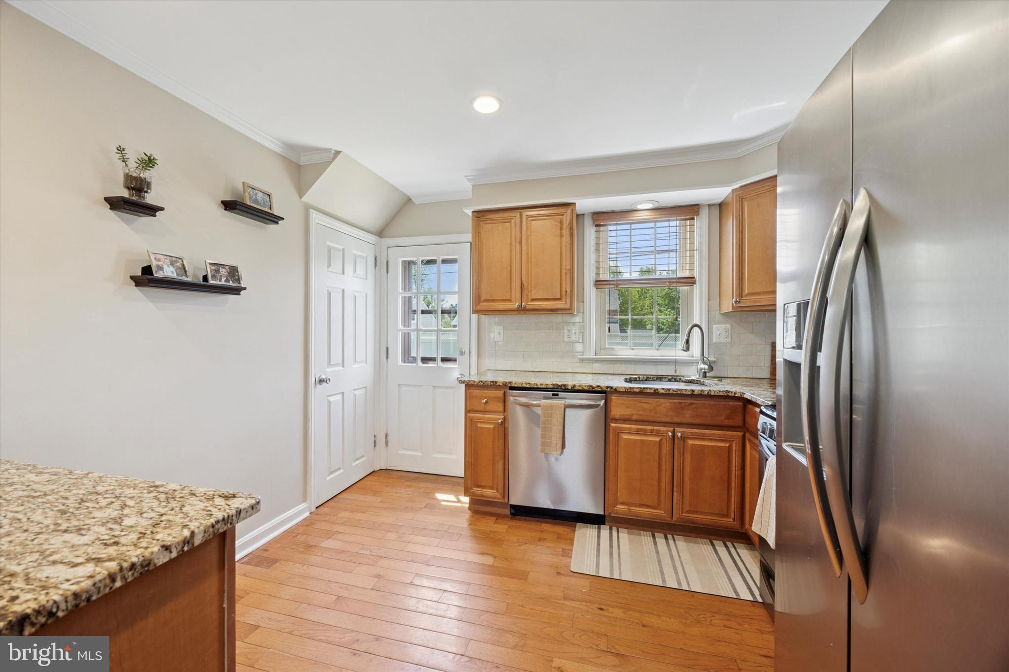 256 Ridgewood Road Springfield, PA 19064 - Photo 13 of 32 a kitchen with stainless steel appliances granite countertop a refrigerator and a sink