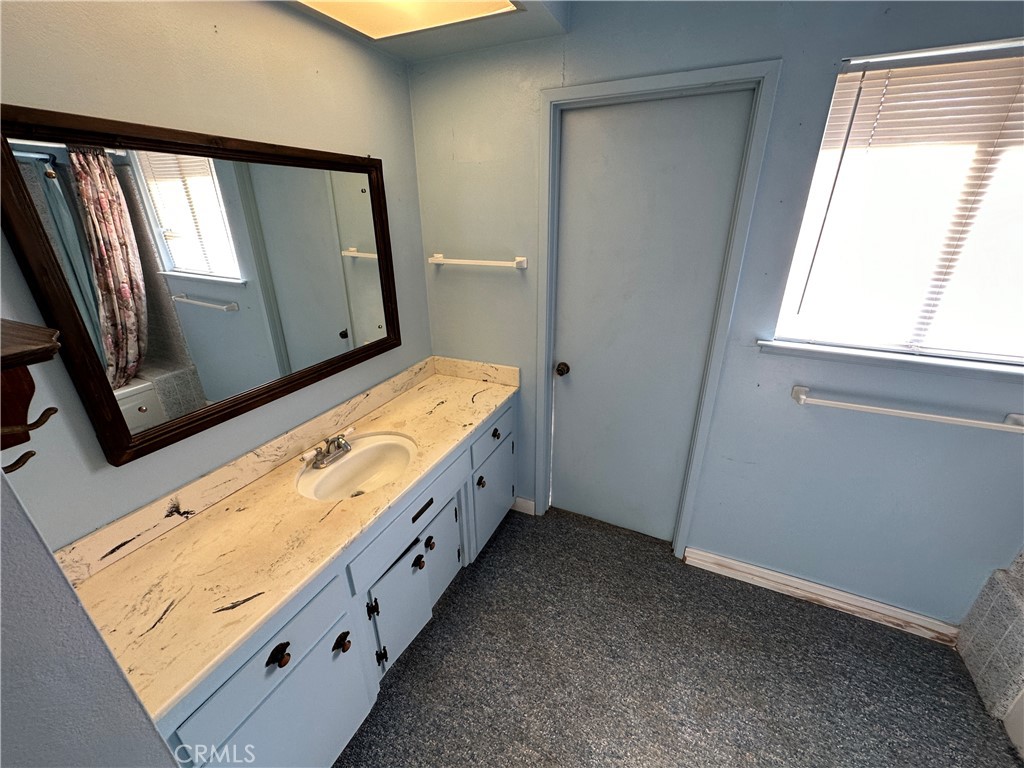 602 Elise Court Merced, CA 95340 - Photo 15 of 20 a bathroom with a granite countertop sink and a mirror