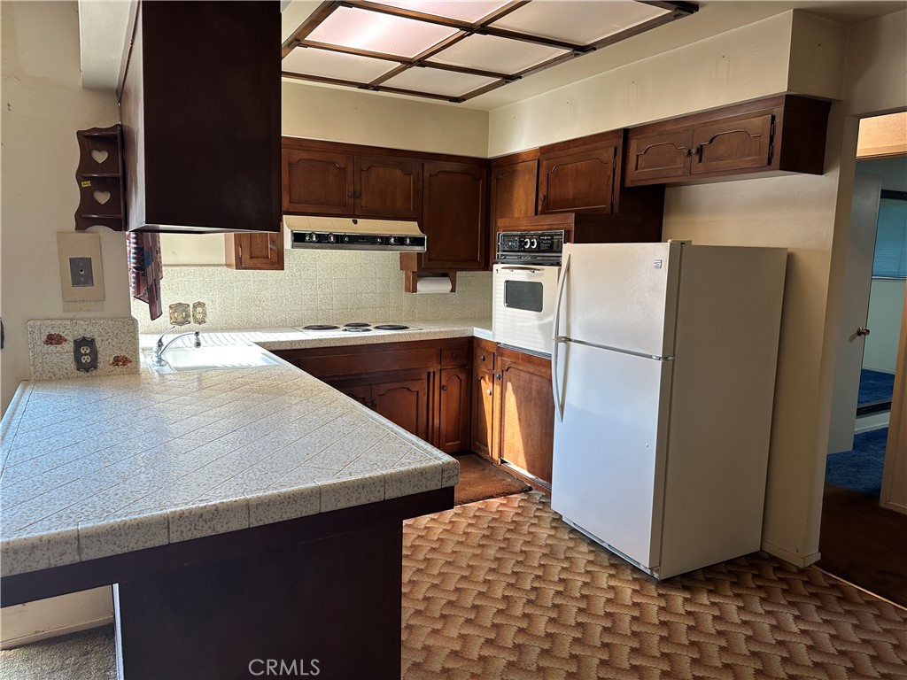 602 Elise Court Merced, CA 95340 - Photo 4 of 20 a kitchen with stainless steel appliances a refrigerator a sink a stove a microwave and cabinets