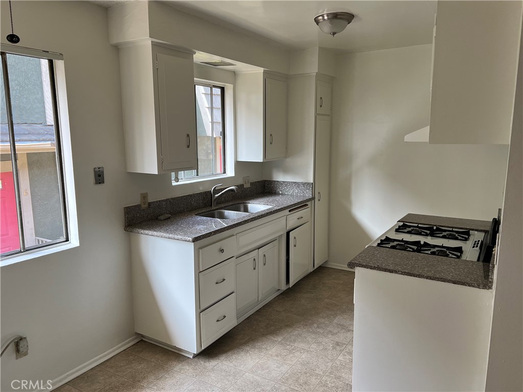 387 North Mentor Avenue, Unit 9 Pasadena, CA 91106 - Photo 1 of 9 a kitchen with granite countertop cabinets a stove and a refrigerator