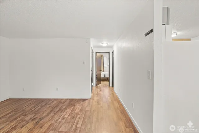 a view of a hallway with wooden floor
