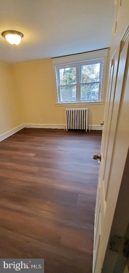 7220 Lamport Road Upper Darby, PA 19082 - Photo 9 of 14 a view of an empty room with a window and wooden floor