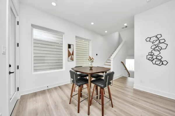 a view of a dining room with furniture and wooden floor