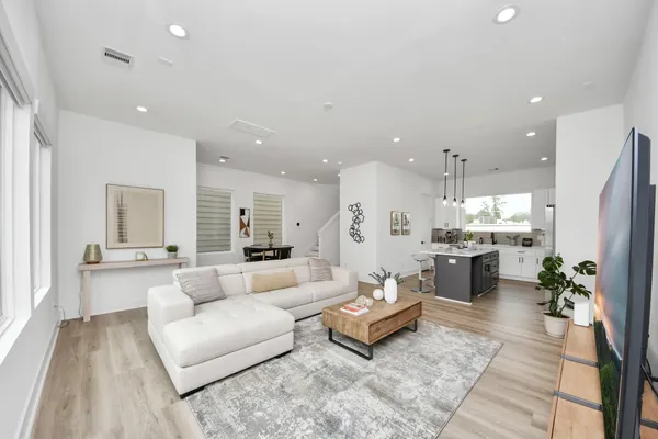 a living room with furniture kitchen area and a couch
