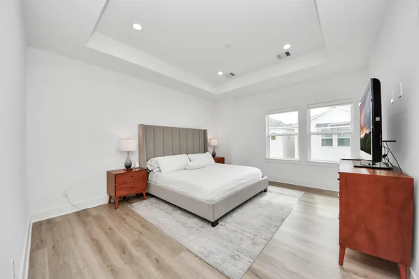 a bedroom with a bed and flat screen tv