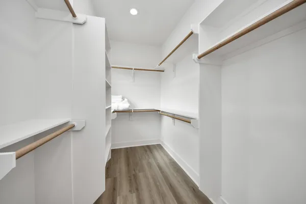 a view of walk in closet with empty racks