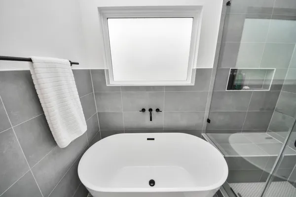 a bathroom with a white bath tub a sink and a toilet