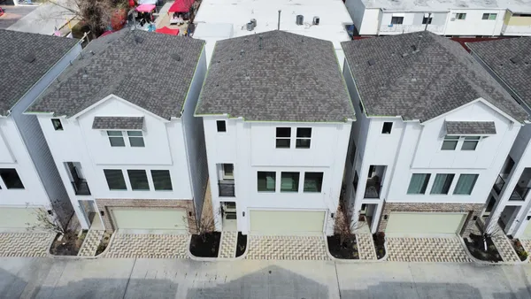 a front view of a house with glass windows and glass door