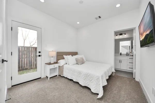 a spacious bedroom with a bed and a view of bedroom