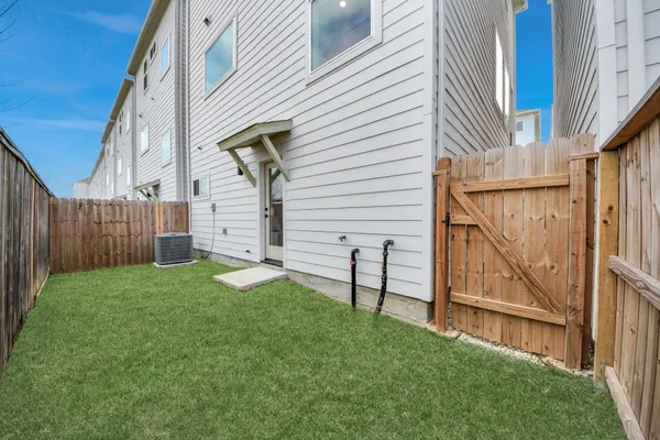 a view of backyard with wooden fence and a stairs