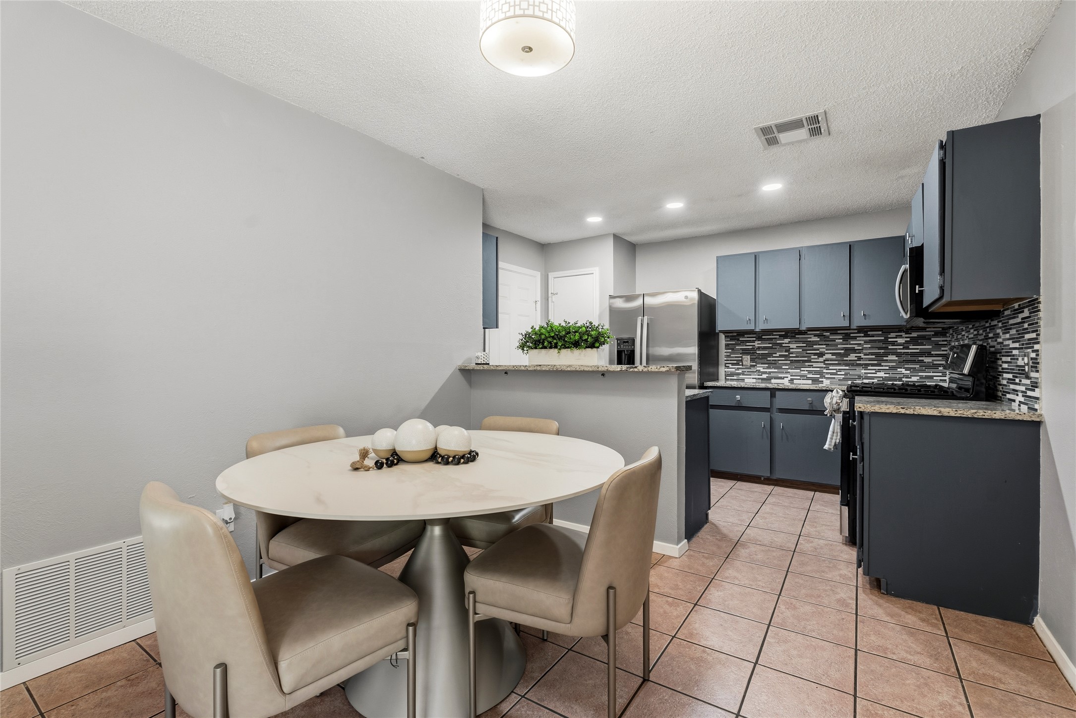12307 Emery Oaks Road Austin, TX 78758 - Photo 14 of 22 Positioned directly between the living room and kitchen, this dedicated dining space keeps meal times closely connected to the conversation in the adjacent areas