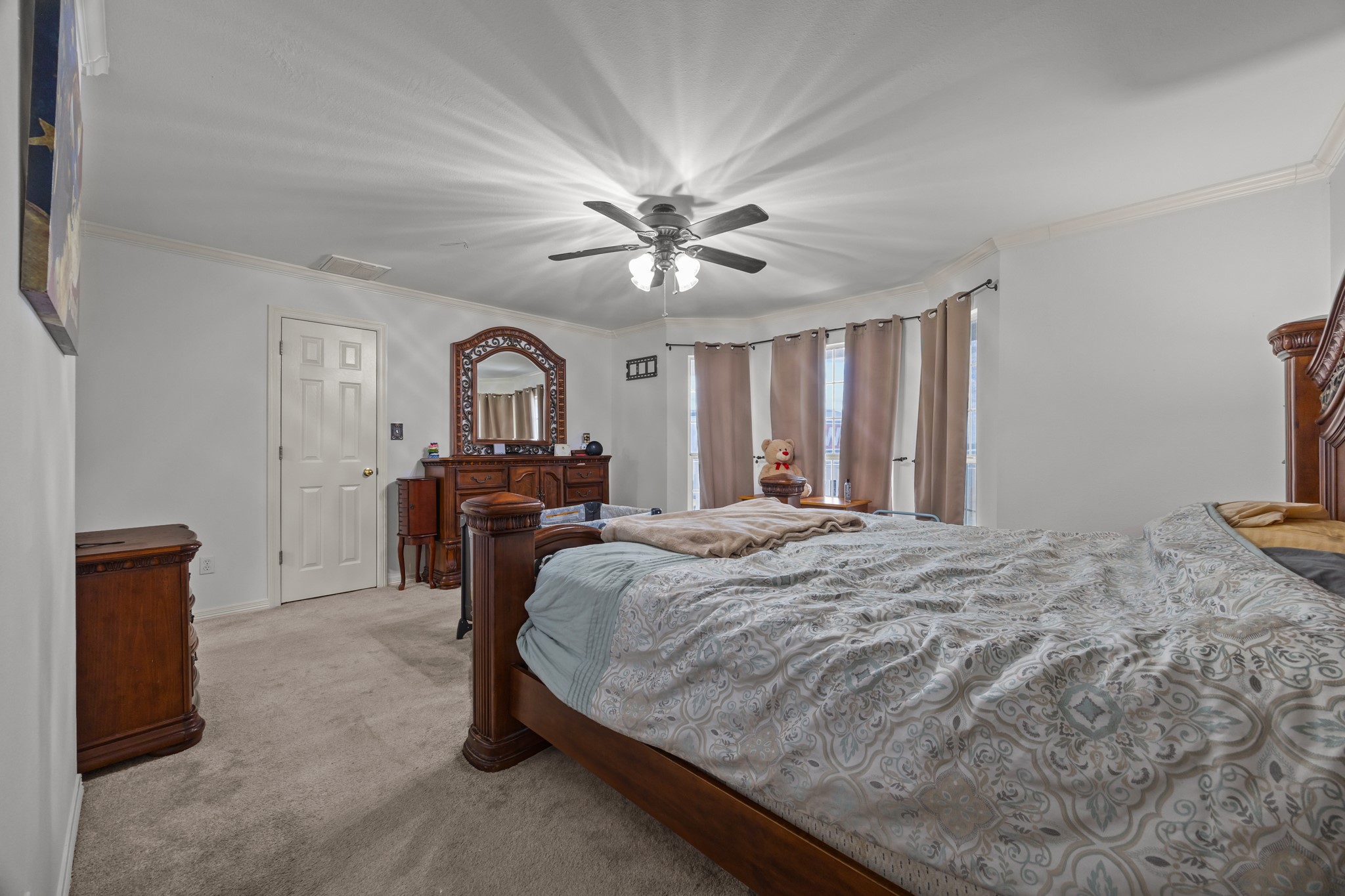 6503 County Road 208 Angleton, TX 77515 - Photo 12 of 38 a bedroom with a bed and a chandelier