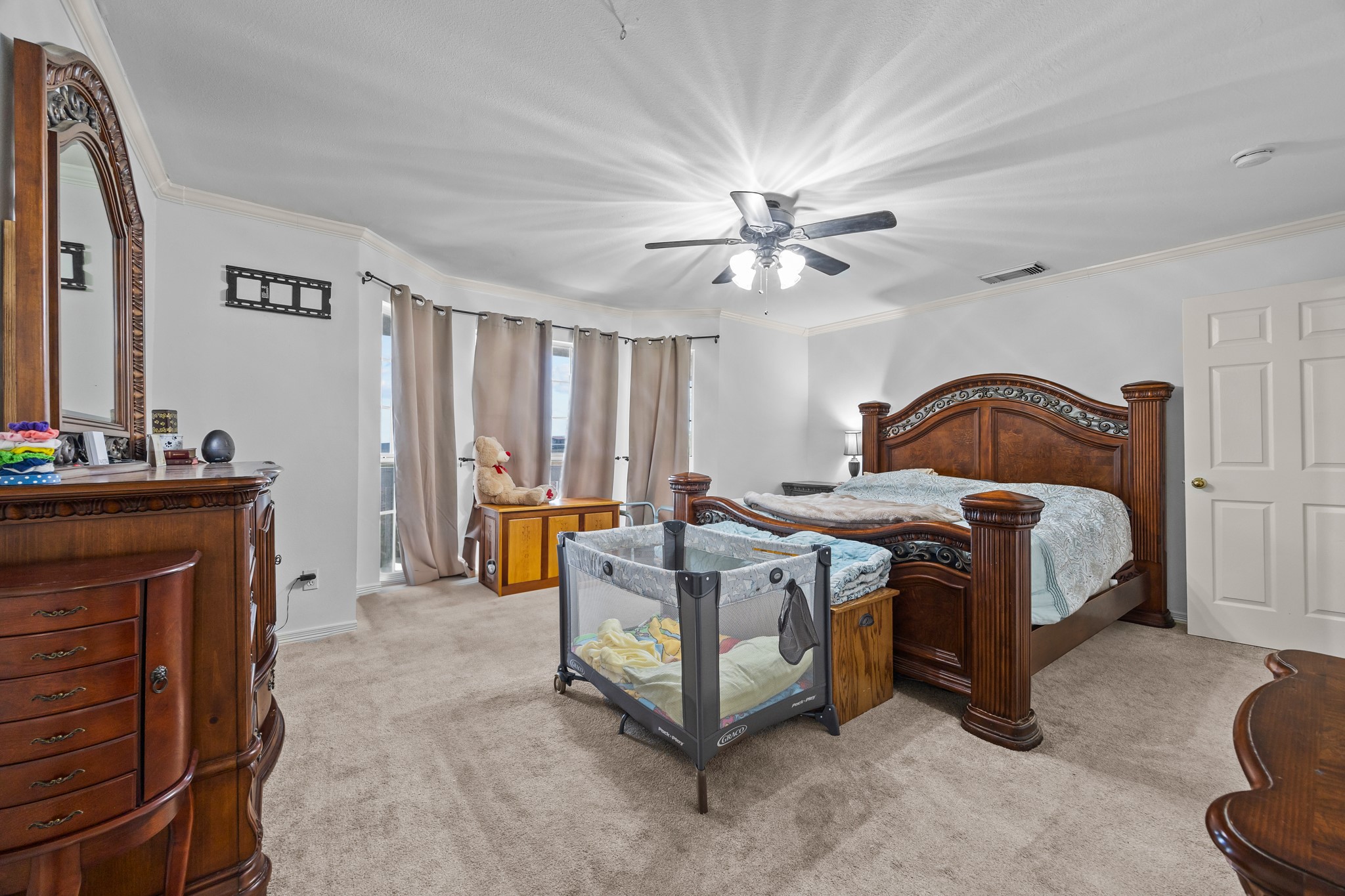 6503 County Road 208 Angleton, TX 77515 - Photo 13 of 38 a spacious bedroom with a bed a chandelier and a fireplace