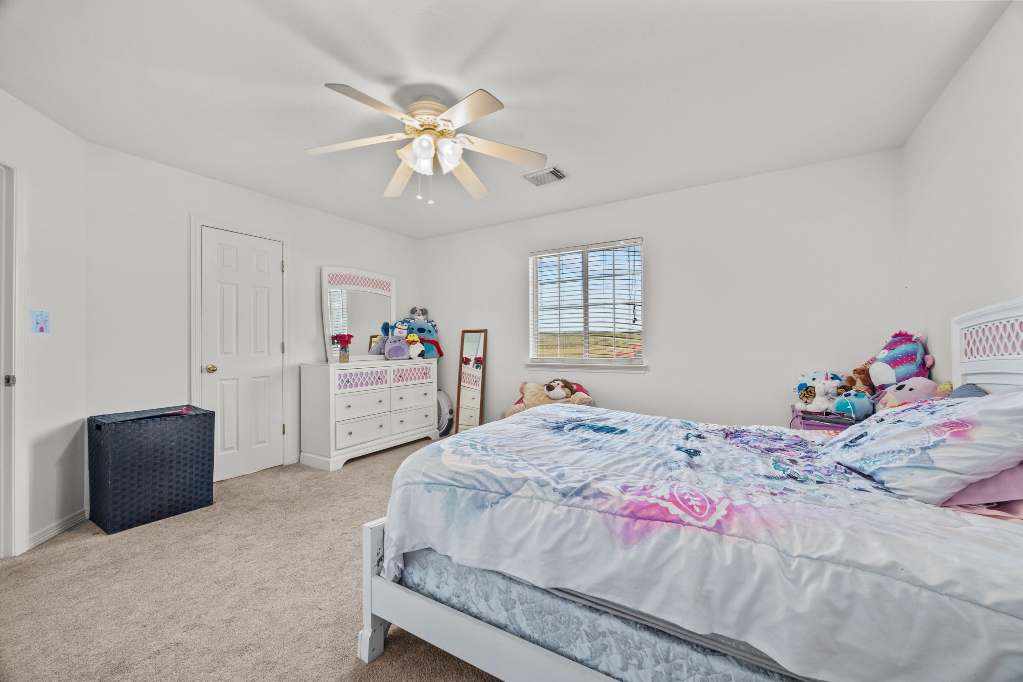 6503 County Road 208 Angleton, TX 77515 - Photo 24 of 38 a bedroom with a bed and a chandelier