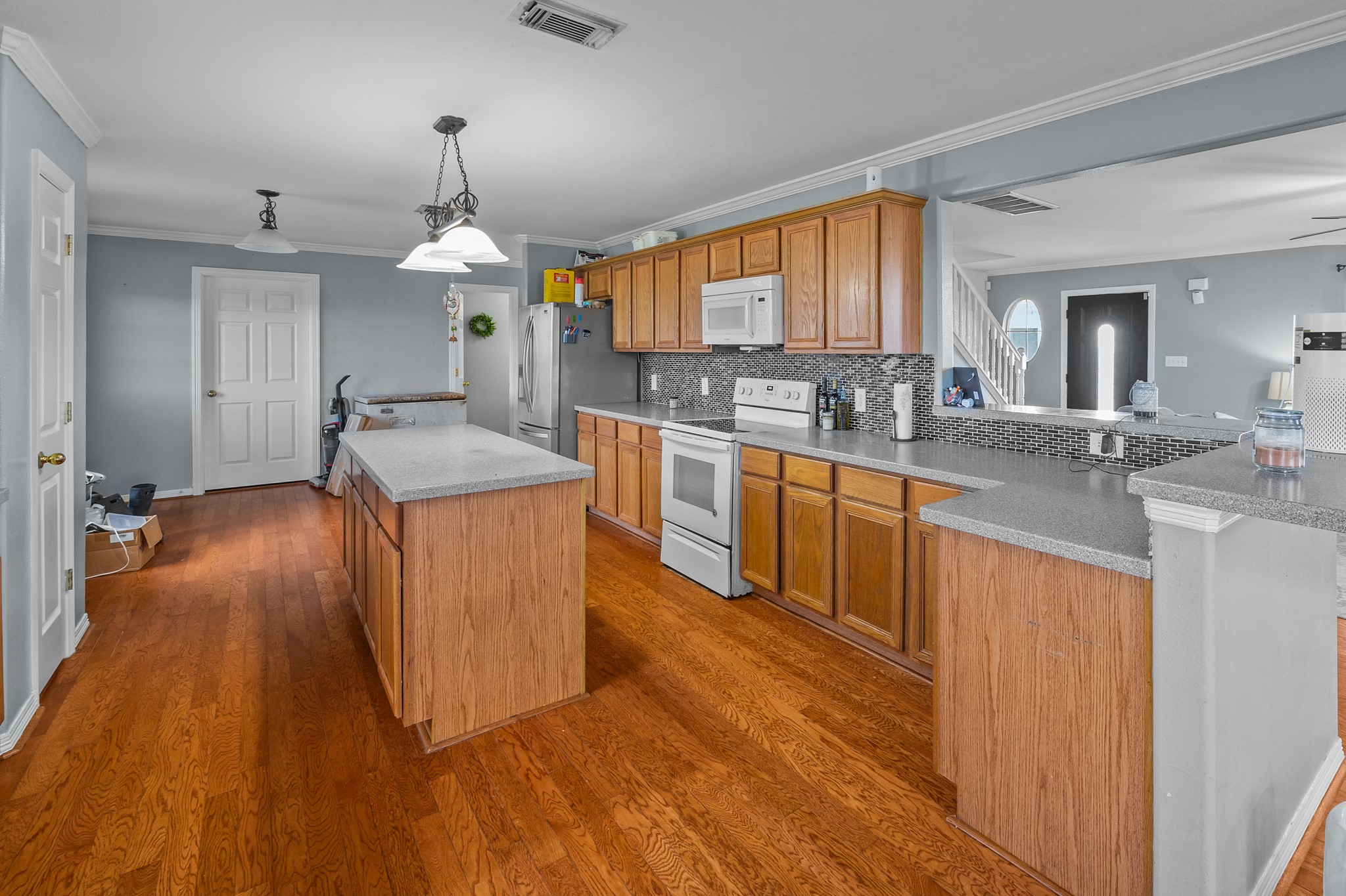 6503 County Road 208 Angleton, TX 77515 - Photo 10 of 38 a kitchen with stainless steel appliances granite countertop wooden floors and sink