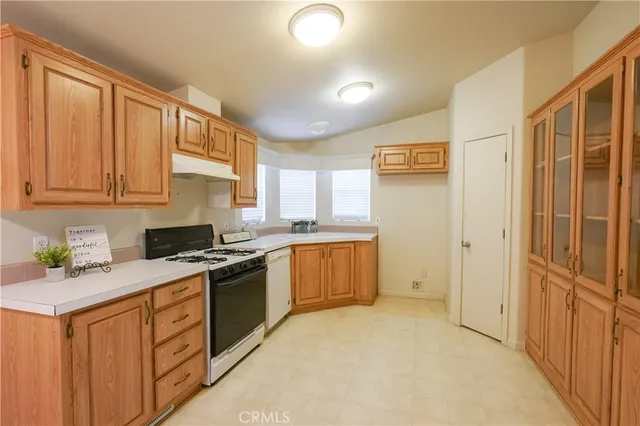 a kitchen with stainless steel appliances granite countertop a stove a sink dishwasher and a refrigerator