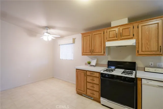 a kitchen with cabinets appliances and a sink