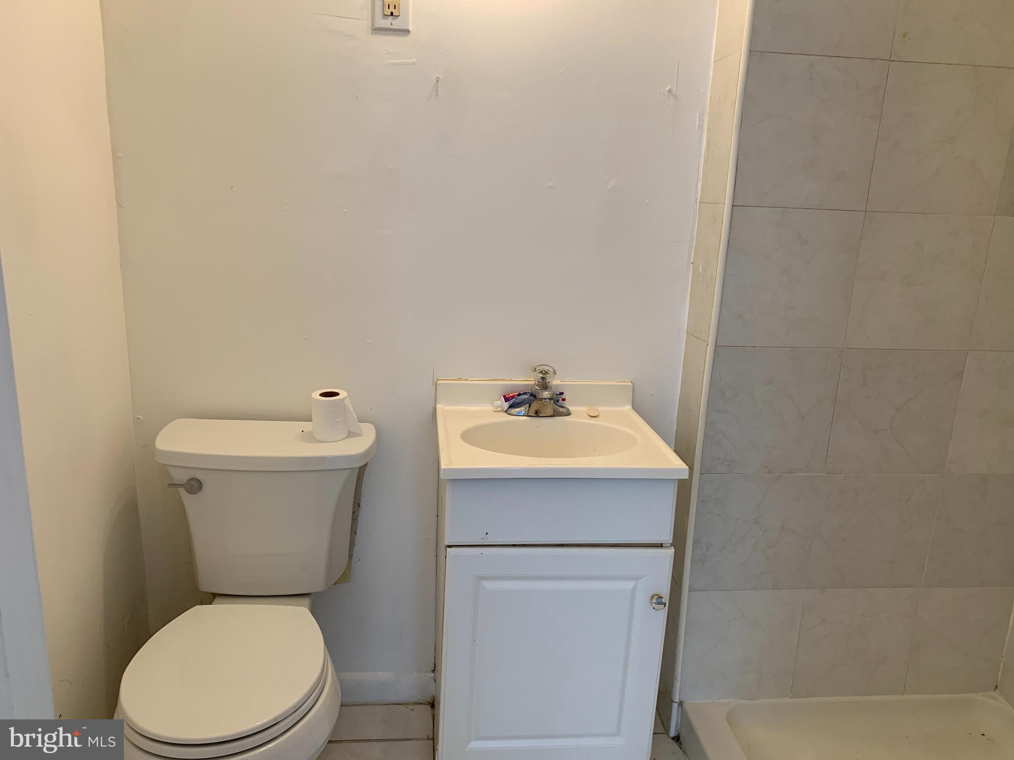 65-69 High Street, Unit 3 Mount Holly, NJ 08060 - Photo 7 of 10 a bathroom with a sink a toilet and a mirror