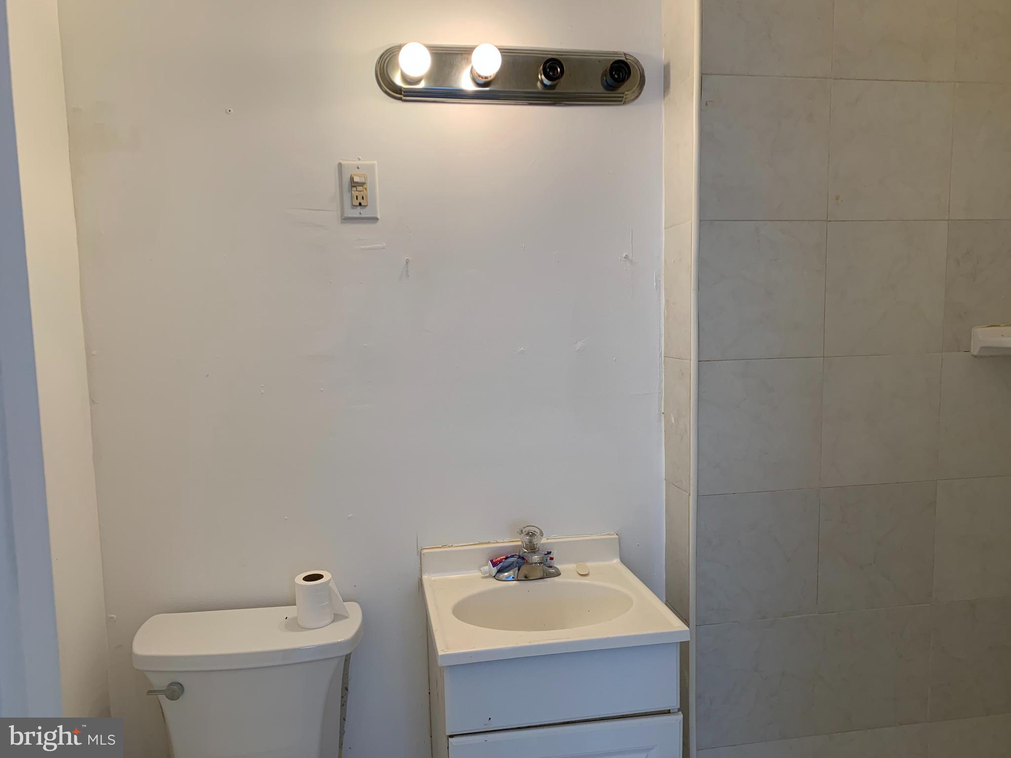 65-69 High Street, Unit 3 Mount Holly, NJ 08060 - Photo 9 of 10 a bathroom with a sink a toilet and mirror
