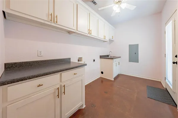 a kitchen with granite countertop white cabinets and white appliances