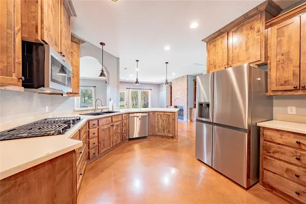 a kitchen with stainless steel appliances a refrigerator sink and microwave