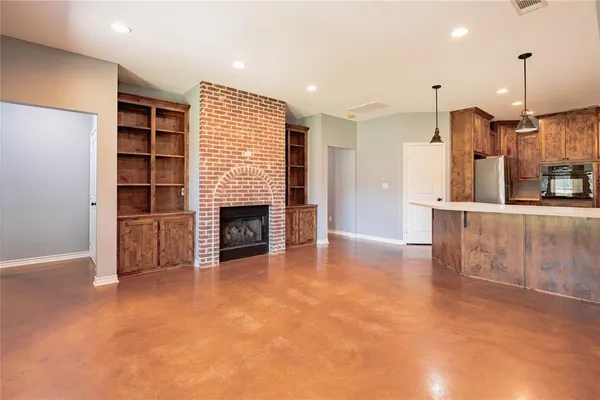 a view of a kitchen with a sink and a fireplace